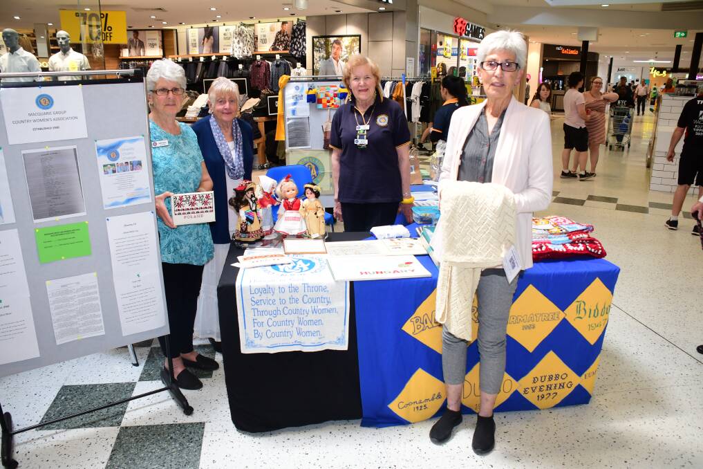 Proud history: Country Women's Association members Judy Reeves, Cath Waller, Hilda Newstead and Karen McHale mark the Macquarie group of branches' 90th anniversary with a display at Orana Mall. Photo: AMY MCINTYRE
