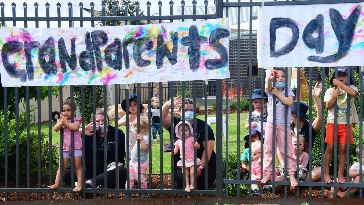 Creativity: Gowrie Early Education Centre Dubbo children and team members ready to show their appreciation to grandparents driving by the grounds decorated for Grandparents Day. Photo: AMY MCINTYRE