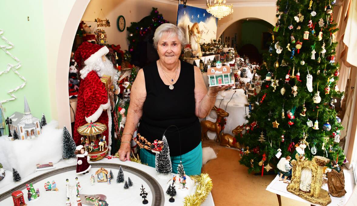 MERRY CHRISTMAS: Margaret Johnston with one of the five little houses that inspired her and her husband's thirty-year tradition. Photo: AMY McINTYRE. 