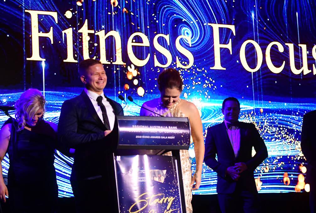 A GOLDEN MOMENT: Rachel and Andrew Bassett with Cris Clark from Fitness Focus. Photo: AMY McINTYRE.