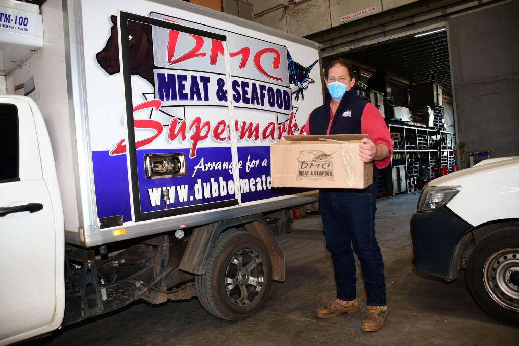 Long hours: DMC Meat & Seafood owner Mark Knaggs with a home delivery, a service in demand in the COVID outbreak. Photo: AMY MCINTYRE