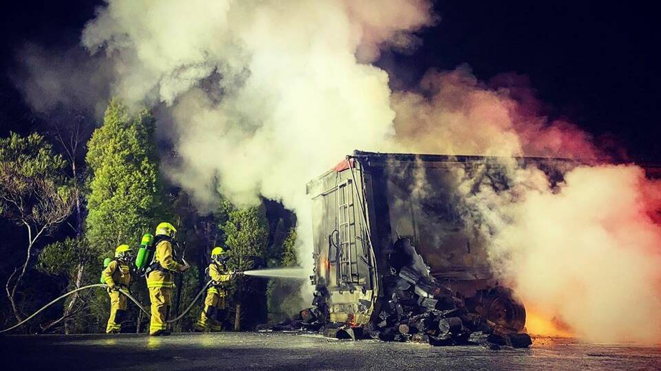 BLAZE: Two separate crews of firefighters working in breathing apparatus to extinguish the truck fire. Photo: PAUL CAVALIER