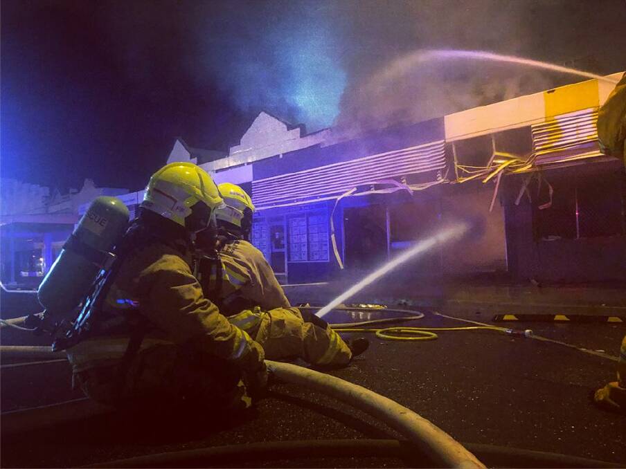 DESTROYED: Firefighters battle a blaze in a row of shops at Coonamble. Photo: PAUL CAVALIER