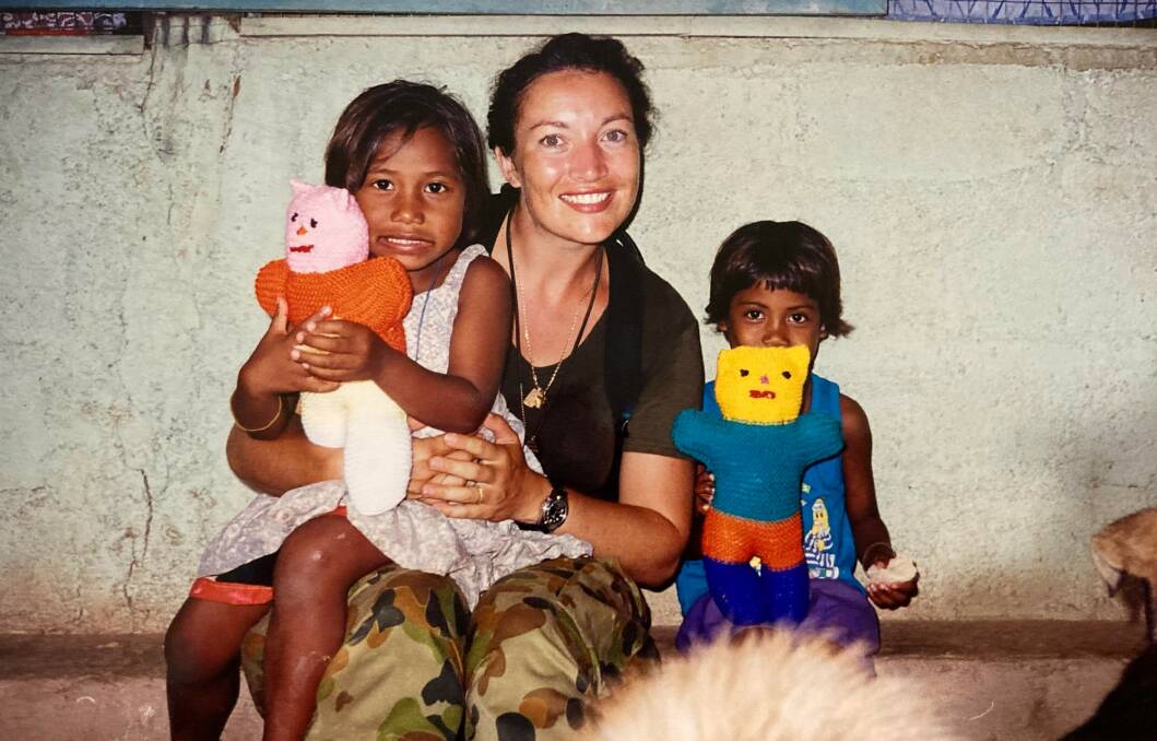 HELPING HANDS: Tamara Sloper-Harding volunteered her time to help mothers and children during her deployment in Timor-Leste. Picture: Supplied
