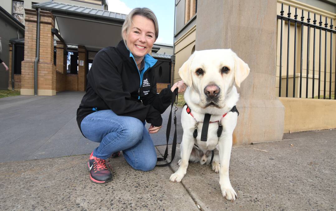 HERE TO HELP: Canine Court Companion volunteer Katy Dunlop and Marshall. Photo: JUDE KEOGH