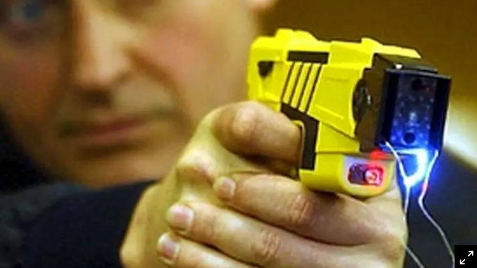MAN ARRESTED: Police draw and aim taser at armed man in street after alleged serious offences. Photo: FILE