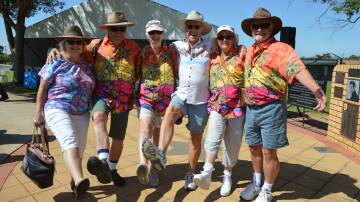Diane Allen, John and Deb Martyn, Noel "Joe Cool" Allen, all of Brisbane, and Margaret and Michael Charles of Goulburn at the Elvis Wall of Fame on January 4, looking very festive for the Parkes Elvis Festival's Blue Hawaii theme. Picture by Christine Little