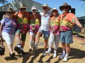 Diane Allen, John and Deb Martyn, Noel "Joe Cool" Allen, all of Brisbane, and Margaret and Michael Charles of Goulburn at the Elvis Wall of Fame on January 4, looking very festive for the Parkes Elvis Festival's Blue Hawaii theme. Picture by Christine Little