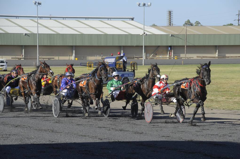 Nathan Hurst has a tight hold on eventual winner Tangles approaching the bell during the running of The Daily Liberal Pace at Dubbo on Wednesday night. Minor placegetters Spruce It Up is on the pegs behind the leader and third placed Pinegrove on the outside. 
 	Photo: BELINDA SOOLE