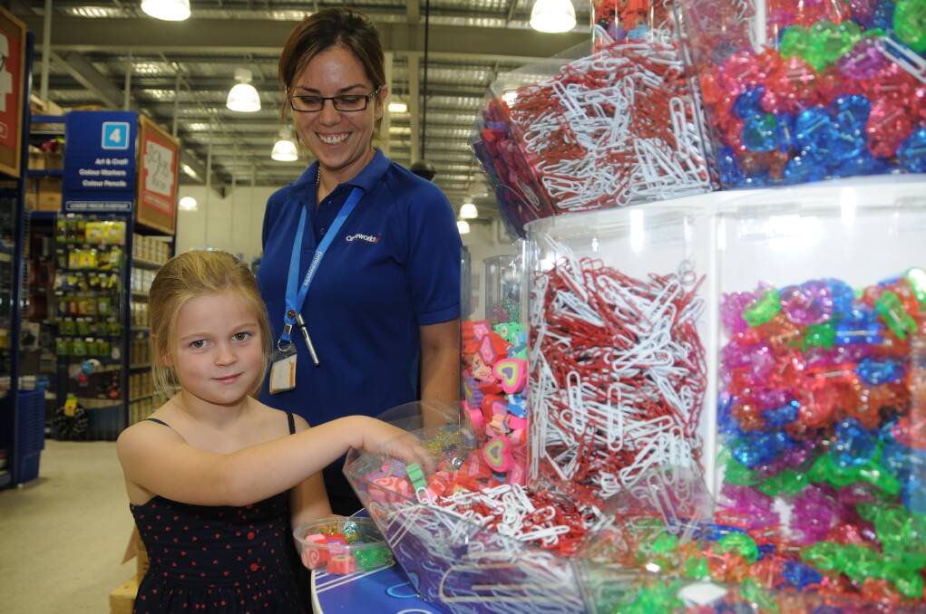 Officeworks manager Naomi Hartley assists Emma Daley during her school shopping. 	Photo: AMY McINTYRE