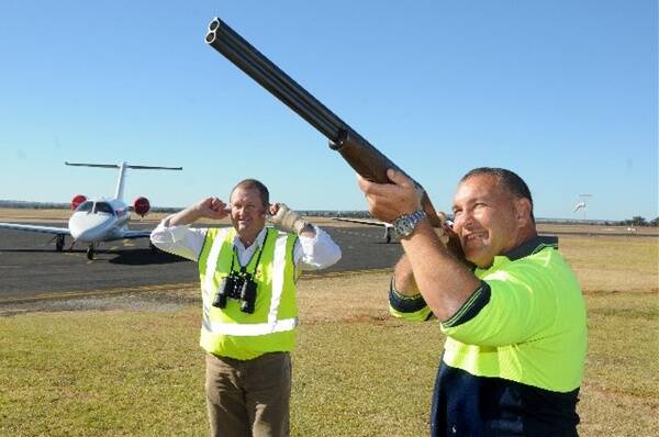 Airport Operations Manager Lindsay Mason and Aerodrome Reporting Officer Ken Fisher scaring birds from the runway. INSET: The bird scaring shotgun shells.	  Photos: AMY MCINTYRE