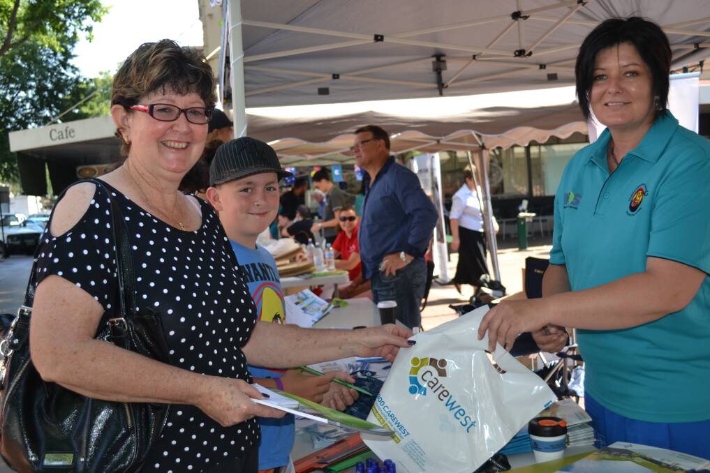 Dubbo residents Annette and Harley Hudson finding out what services are avaliable from Carewest Aborginal services adviser Lisa Austin at the National Disablity Awareness Day on Macquarie Street. PHOTO: ABANOB SAAD.