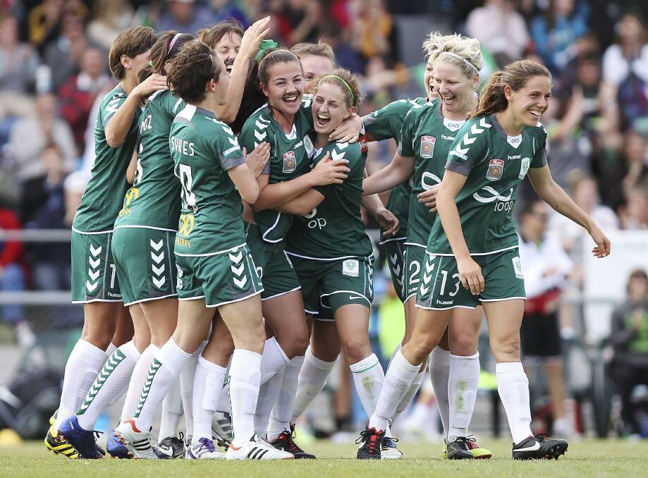 Dubbo's Ashleigh and Nicole Sykes help Sammie Wood celebrate a goal. 							       Photo: GETTY IMAGES