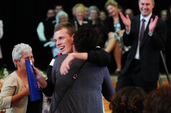 Jordan Primmer hugging his mother Denise at his graduation ceremony.