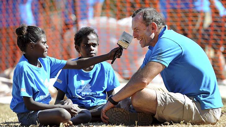 Leading by example... Tony Abbott with children in Aurukun yesterday.