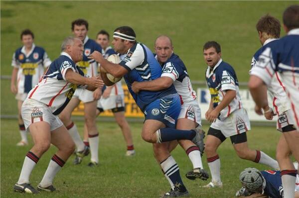 Ian Prendergast (left) and Peter Ford combine to bring down Macquarie prop Kyle Webb.