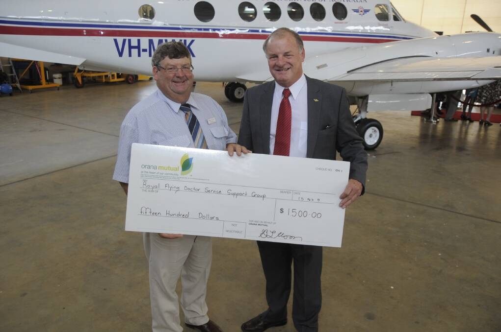 RIGHT: Dubbo Show Society president Marty Morris handing over a token of thanks to the Dubbo Royal Flying Doctor support group president Terry Clark for their help feeding more than 3000 people. 	 
Photo: BELINDA SOOLE