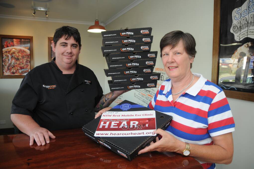Pizza Capers manager Victor Brook and Hear Our Heart Ear Bus Project's Sue Went ahead of today's charity day. 
Photo: AMY MCINTYRE