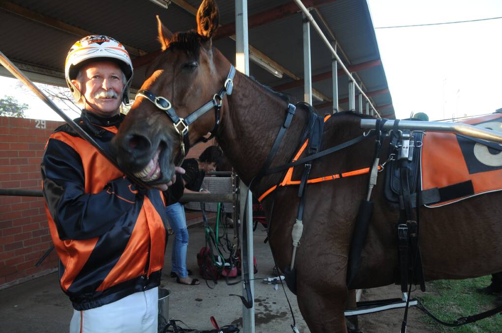 Gary Williams and Happy Camper were both all smiles after winning at the Dubbo Paceway on Saturday night. 		 Photo: CHERYL BURKE