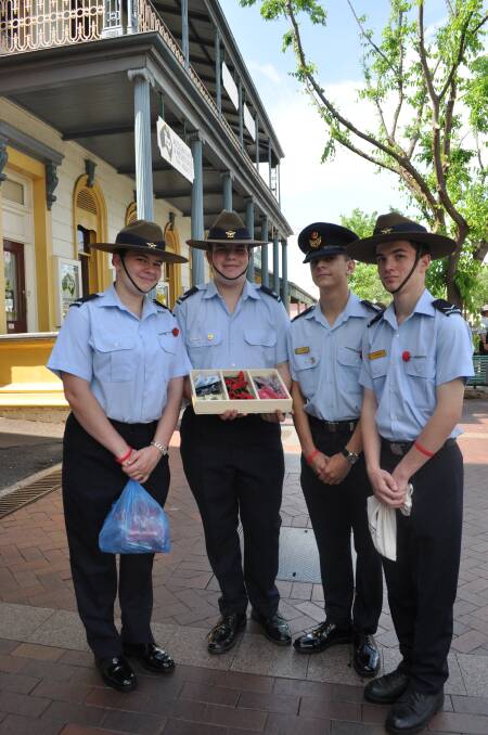 Paying their respects by selling red poppies and other Remembrance Day merchandise are Cadet Nicole Groenestein, Cadet Corporal Angus Brander, Cadet Warrant Officer Leslie Roche and Leading Cadet Liam McGree. 	Photo: ANTHONY CINI