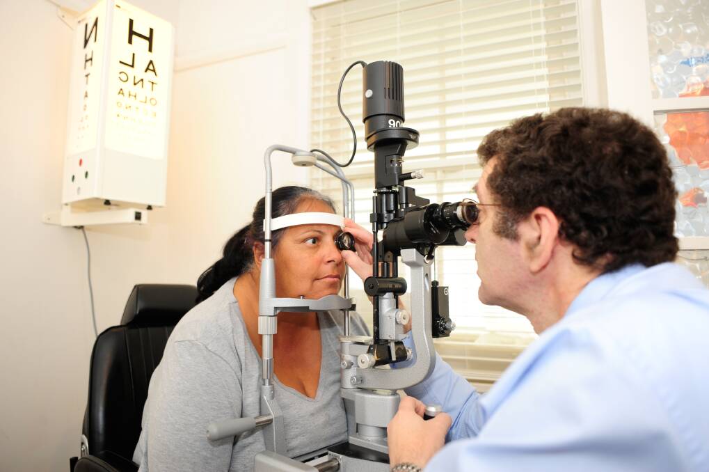 Dr Paul Adler checking the eyes of Tania Button at the new public eye clinic on Bourke Street. Photo: Belinda Soole