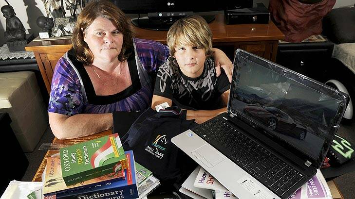 Rhonda Coyne and her son Jamie, surrounded by expensive school supplies.
