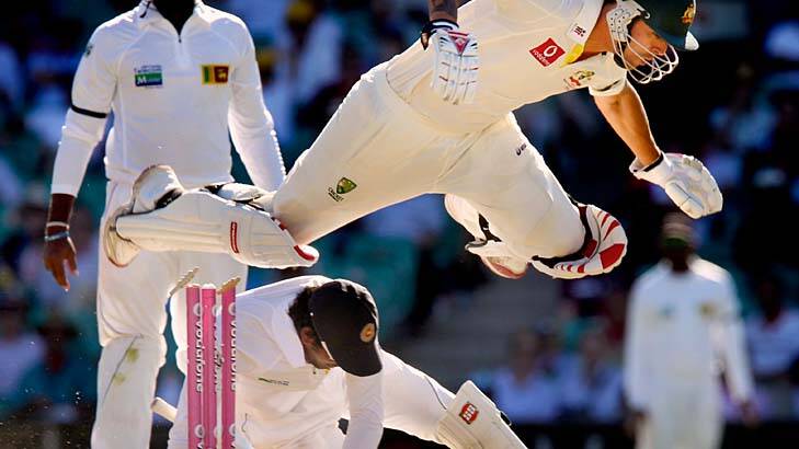 Crash through ... Mitchell Johnson takes to the air over the wicketkeeper to reach the crease against Sri Lanka at the SCG on Saturday.