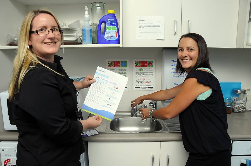 Mel Morgan and Bec Eade from Dubbo City Council's water supply and sewer branch make good use of the water that flows readily from the tap. 
Photo: BELINDA SOOLE