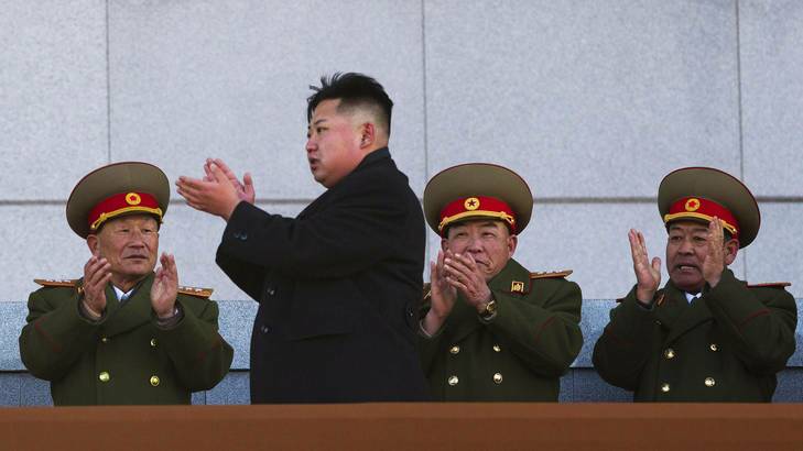 Kim Jong Un, second from left, applauds as he leaves the stands at Kumsusan Memorial Palace in Pyongyang after reviewing a parade of thousands of soldiers and commemorating the 70th birthday of the late Kim Jong Il.