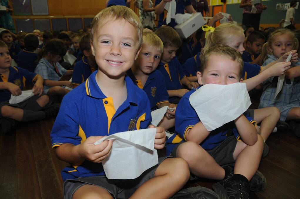 Dubbo South Public School kindy students Max Baker, Chase Moses and (rear) Patrick Brett practise blowing their noses with tissues. 
Photo: AMY McINTYRE