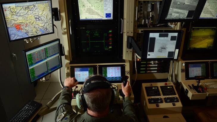 A pilot works the controls of a remotely piloted aircraft at a control station at Hancock Field Air National Guard Base, NY.