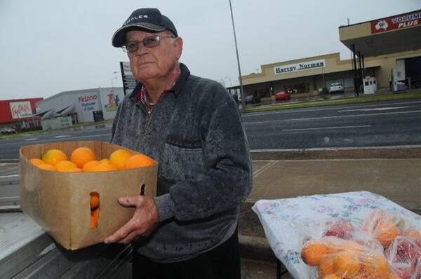Dennis Crowley is frustrated he cannot sell his oranges, mandarins and tomatoes after the council kicked him off the side of the road next to Apex Oval. 				        Photo: JOSH HEARD
