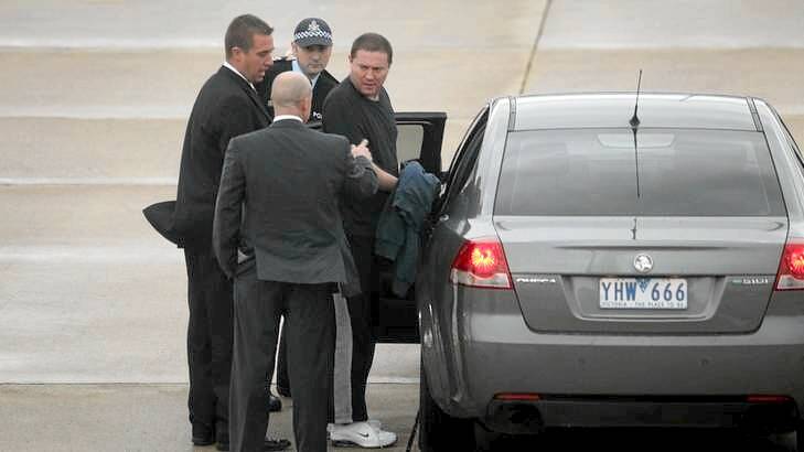 Warren Shea at Melbourne Airport after being extradited from Queensland charged with the murder of Shane Chartres-Abbott.
