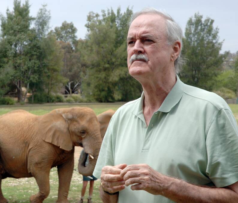 International comedian and actor John Cleese surveys the elephant exhibit during his visit to Taronga Western Plains Zoo in 2006. 	     	       		    Photo: BELINDA SOOLE