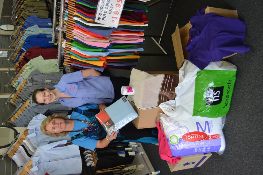 Dubbo s Virigina Carter Erin Hall take stock of donations. (INSET) 
Collections from yesterday.