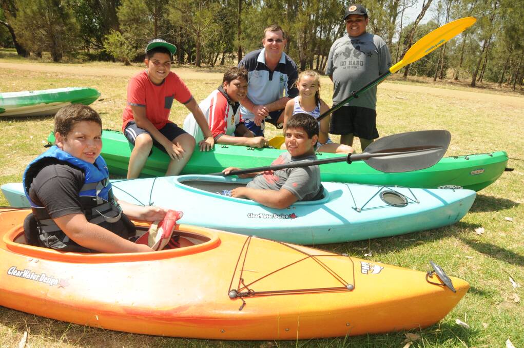 Charles Wilson, Ian Pritchell, Paul Brandon, Taliah King, Zac Waring, (front) Kayden Weldon and Keith Waring get ready to kayak on the Macquarie River yesterday as part of a three-day river and weir safety program. 								  Photo: AMY MCINTYRE
