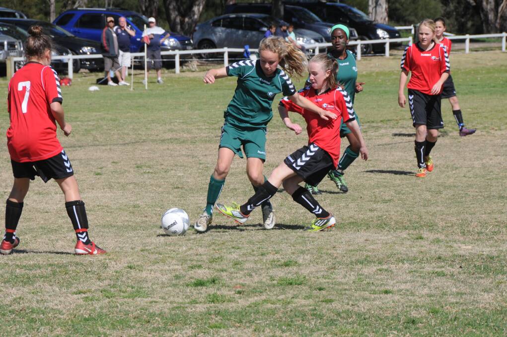 Beth Bernardi (Forbes) does her best to gain possession for Western under-12s against Metro West on day one of the NSW Girls Soccer Championships being played at Dubbo's Lady Cutler complex. 	Photo: BELINDA SOOLE