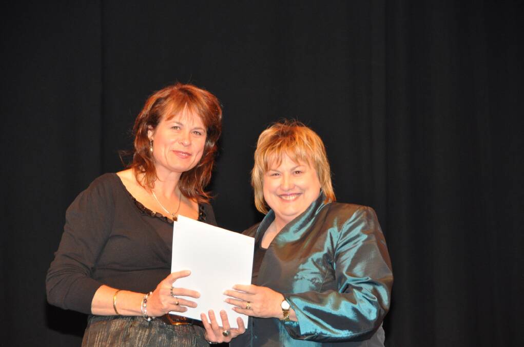 Dubbo College teacher Jules Marshall receives her 20 years service award from school education director Ann-marie Furney.