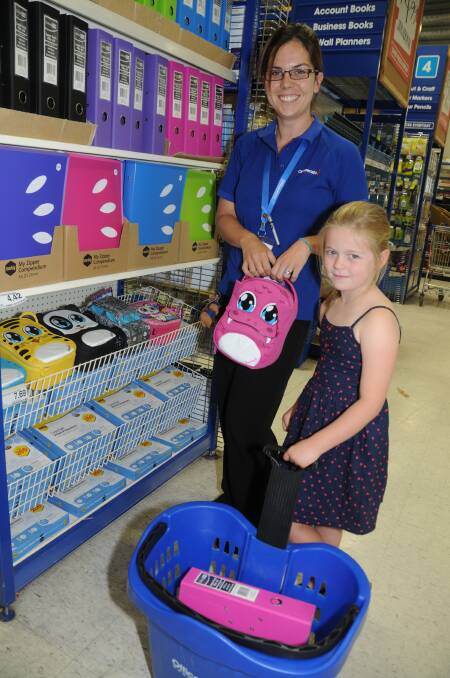 Officeworks manager Naomi Hartley assists Emma Daley during her school shopping. 	Photo: AMY McINTYRE
