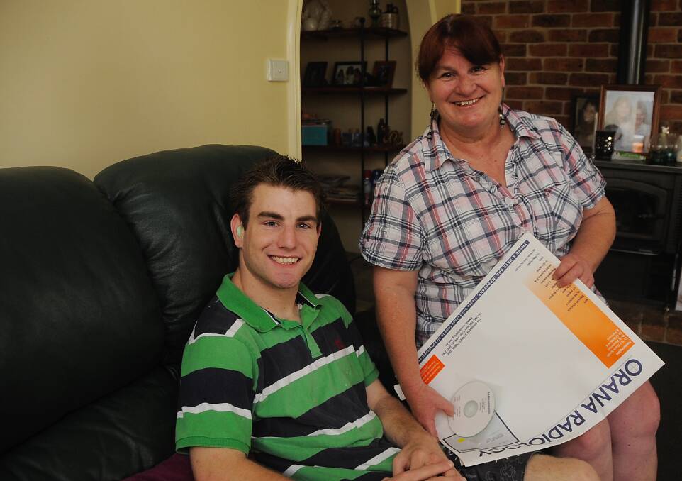 Multiple sclerosis sufferer Joy Butcher tells her son Luke of the new telemedicine facility in Dubbo. Photo: BELINDA SOOLE
