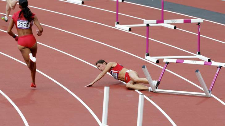 Vania stumbles over ... Bulgarian athlete Vania Stambolova misses the first hurdle in the womens' 400-metre event.