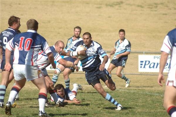 Peter Ford, pictured here on the left attempting to tackle Macquarie’s David Peachey, will have sole coaching responsibilities for the Cobar Roosters in the 2009 Tooheys New Group 11 Rugby League season.