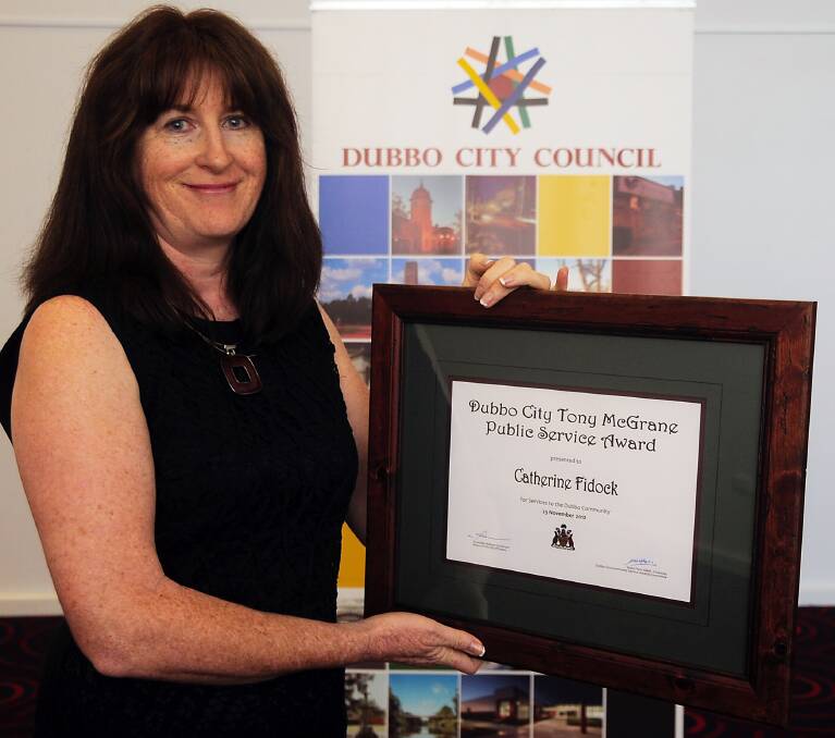 Dubbo resident Catherine Fidock holding the Tony McGrane Public Service Award for her efforts in improving the mental health of young people in the city. 				                		      Photo: BELINDA SOOLE