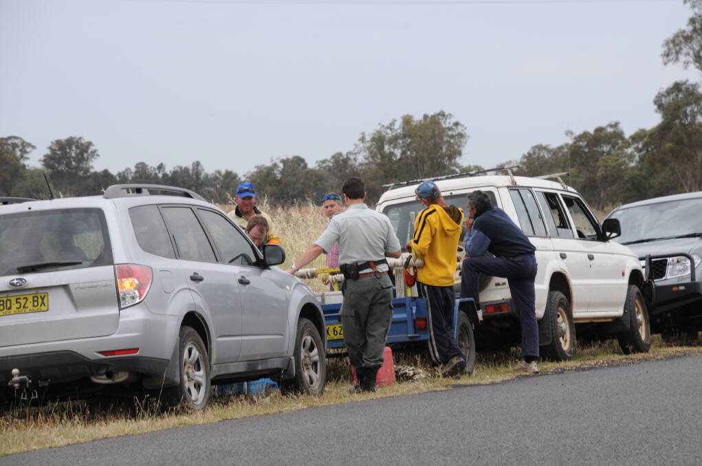 Police and fishing inspectors serch a vehicle after a covert operation on the Macqarie River in October last year. File photo: LISA MINNER