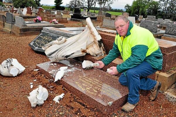 Parkes Shire Council employee Geoff Finn couldn’t believe the carnage caused by vandals at the Parkes Cemetery. Damage to this memorial alone is estimated at $40,000. Photo: Bill Jayet