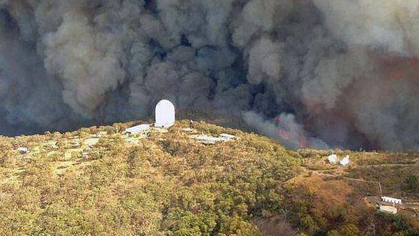 The fire earlier this year as it rages towards the Siding Spring Observatory. Relief funding claims will close on July 16 for residents in the area. Photo: NSW Rural Fire Service 