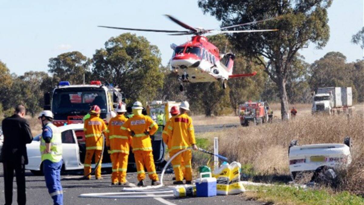Emergency services arrive at the scene of a head-on collision 21 kilometres west of Dubbo yesterday.	Photo: BELINDA SOOLE