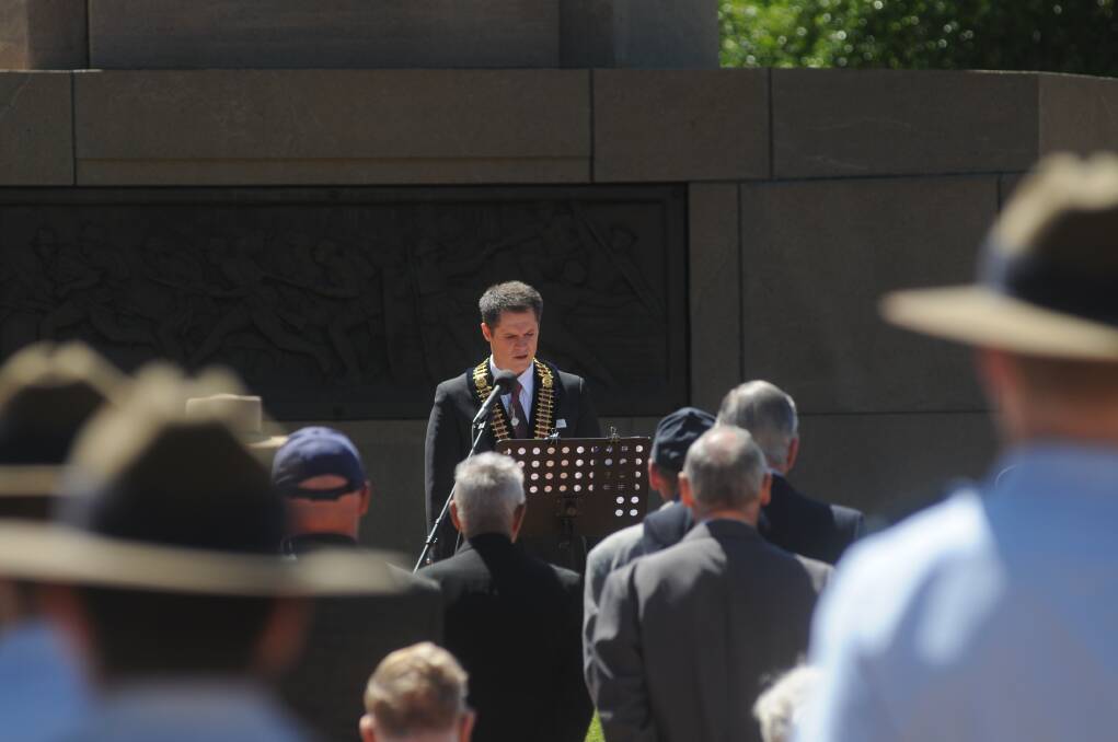 Mayor Mathew Dickerson addressing the crowd at the Remembrance Day ceremony. Photo: JOSH HEARD