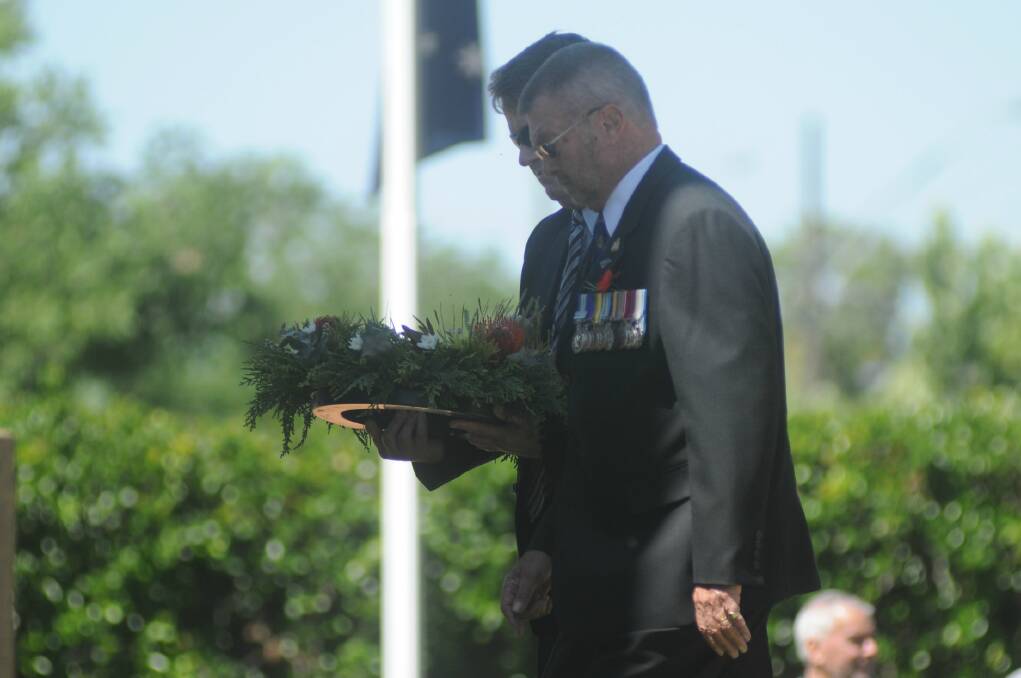 Dubbo RSL Sub Branch president Tom Gray lays a wreath at the Remembrance Day ceremony. Photo: JOSH HEARD