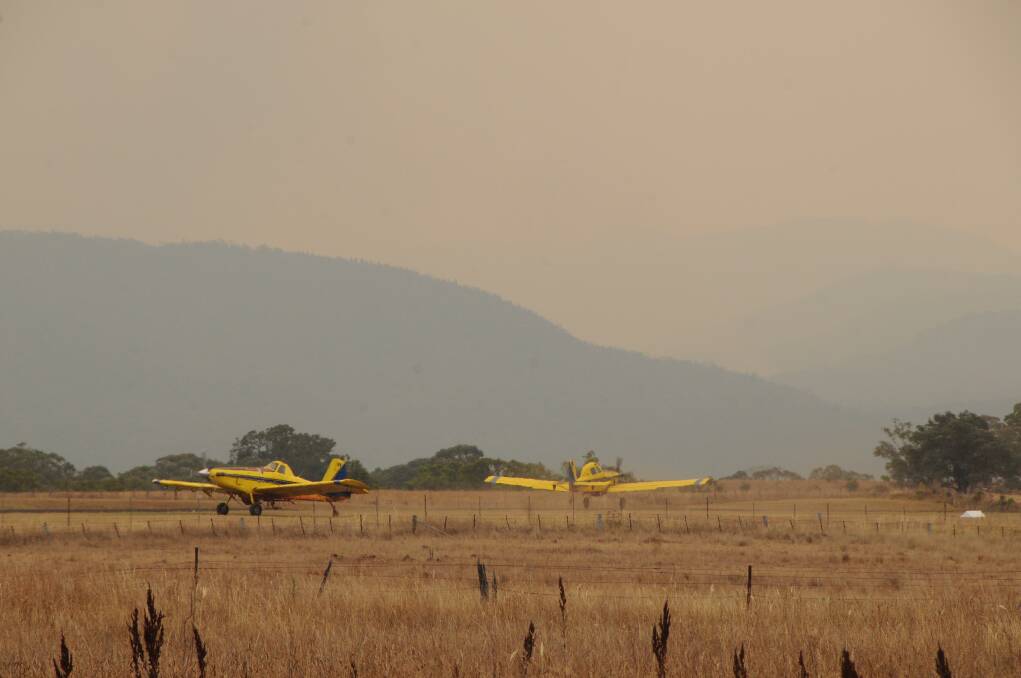 Support crews at the Coonabarabran Aerodrome were flat out filling planes with water and fire retardent. 	Photos: AMY McINTYRE